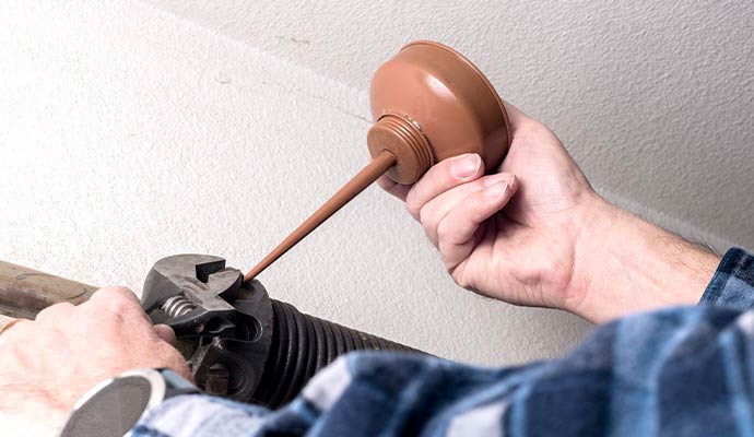 Applying oil to garage door springs