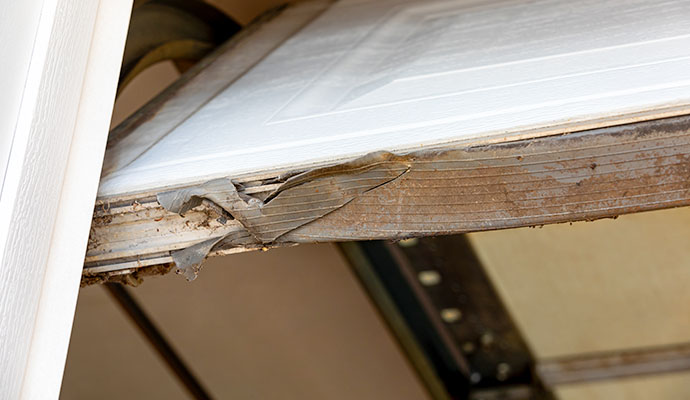 Close-up of a damaged garage door weather seal