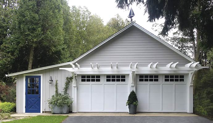 Detached two car garage with white garage doors