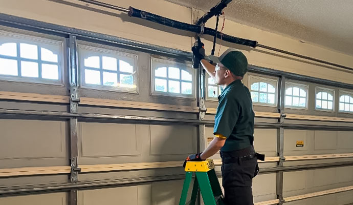 Expert inspecting garage door opener