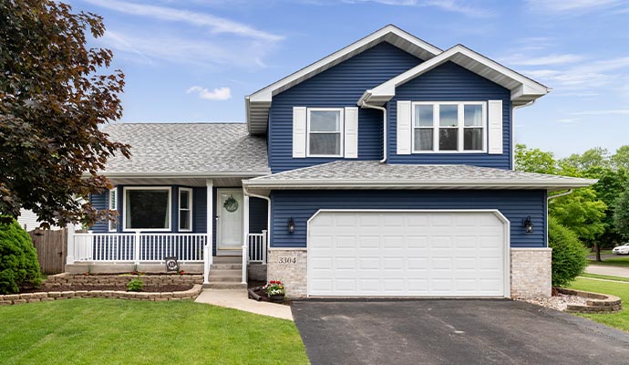 Exterior view of a home with a clean white garage door