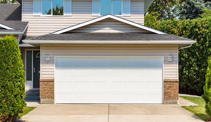 Front view of a white double garage door on a modern residential exterior