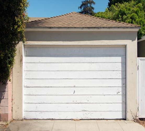 Old white garage door of a residential house
