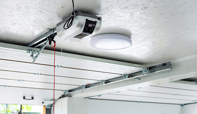 Garage door opener motor unit mounted on ceiling