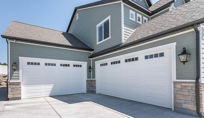 Modern white garage doors on residential exterior