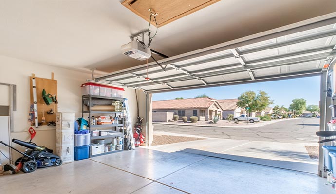 Open residential garage interior with shelves and equipment visible