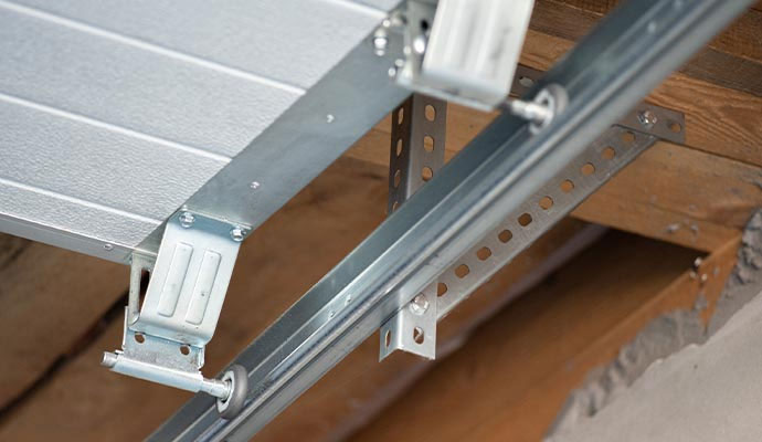 Garage door rollers and brackets installed in overhead track