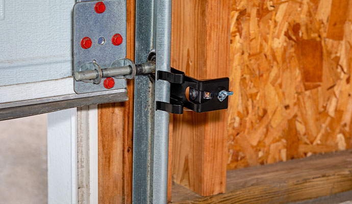 Garage door safety sensor mounted on track