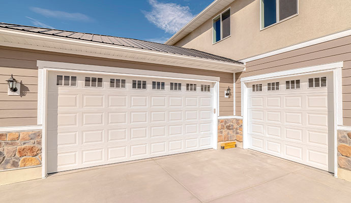 Modern white garage doors on residential exterior