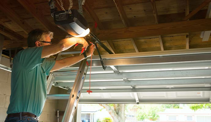 Technician repairing overhead garage door opener