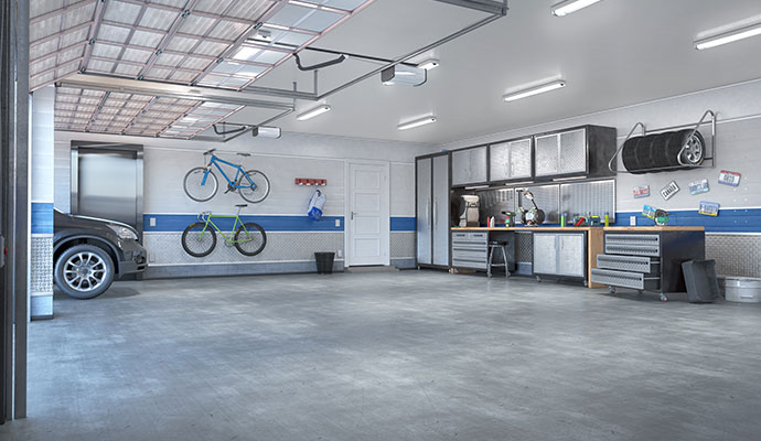 Garage makeover featuring wall-mounted bike racks, sleek metal cabinets and an organized workbench