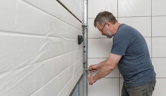 An expert repairing garage door