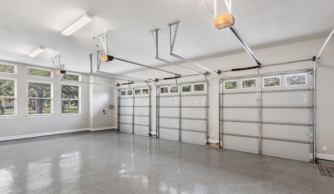 Modern and spacious three-car garage interior featuring organized storage and vehicle space