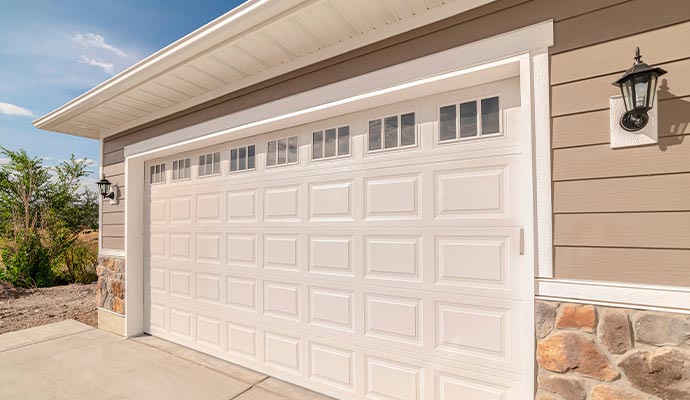 White raised panel garage door with decorative windows